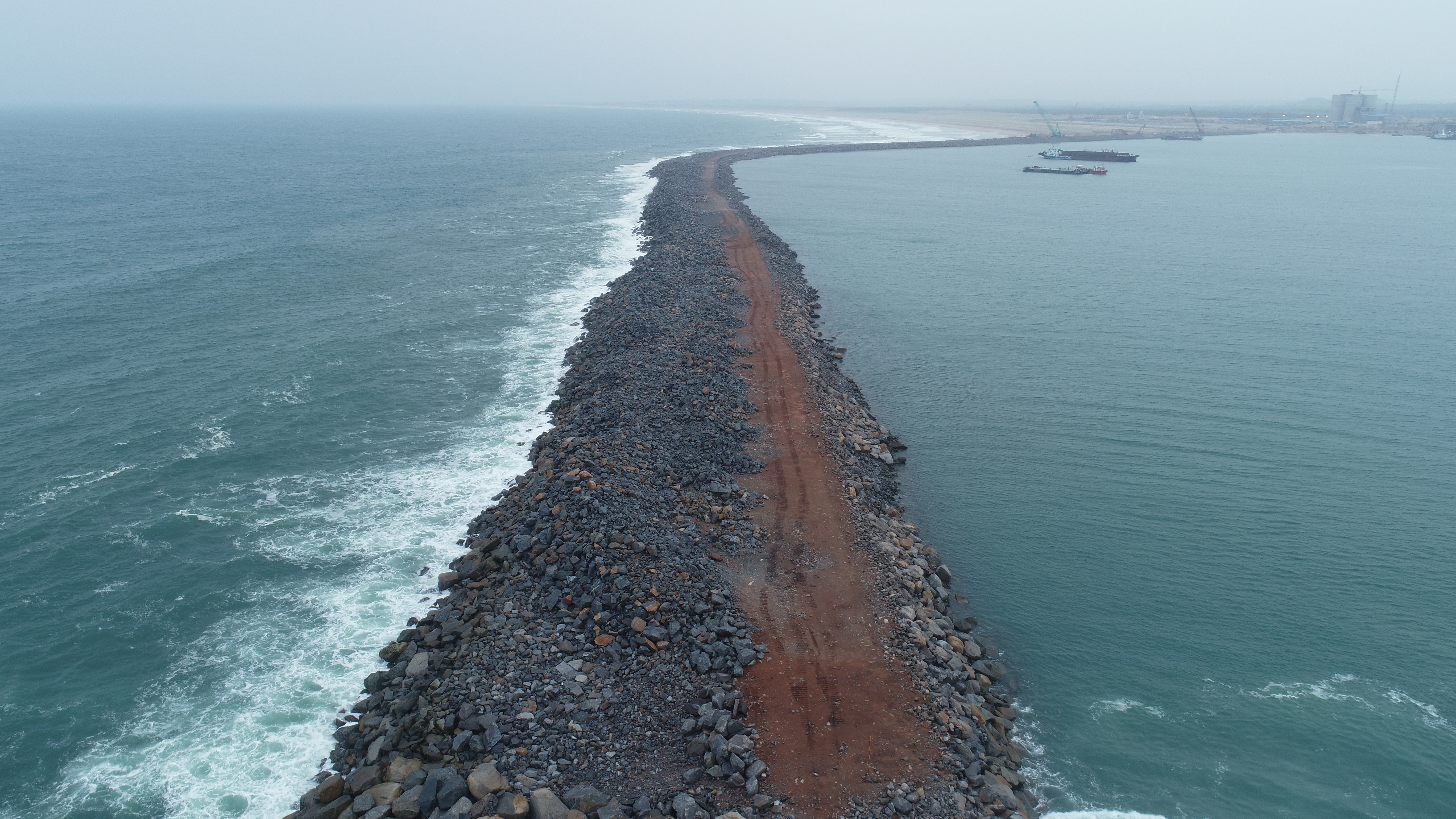 The project involves rehabilitation and construction of two breakwaters destroyed by the Phailin cyclone
