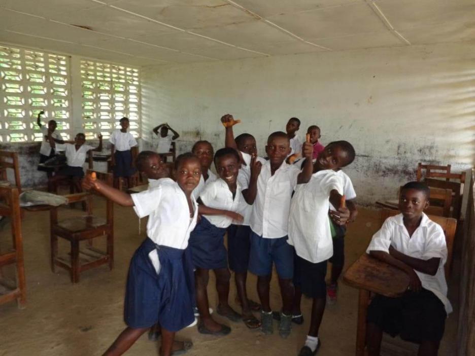 School children take a break after partaking their mid-day meal