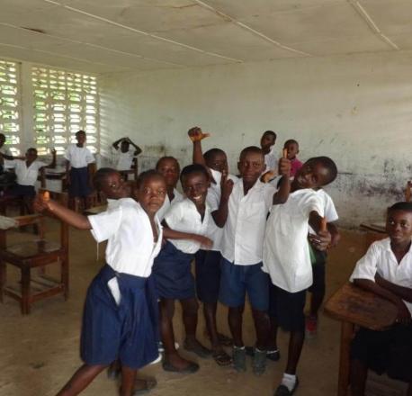 School children take a break after partaking their mid-day meal